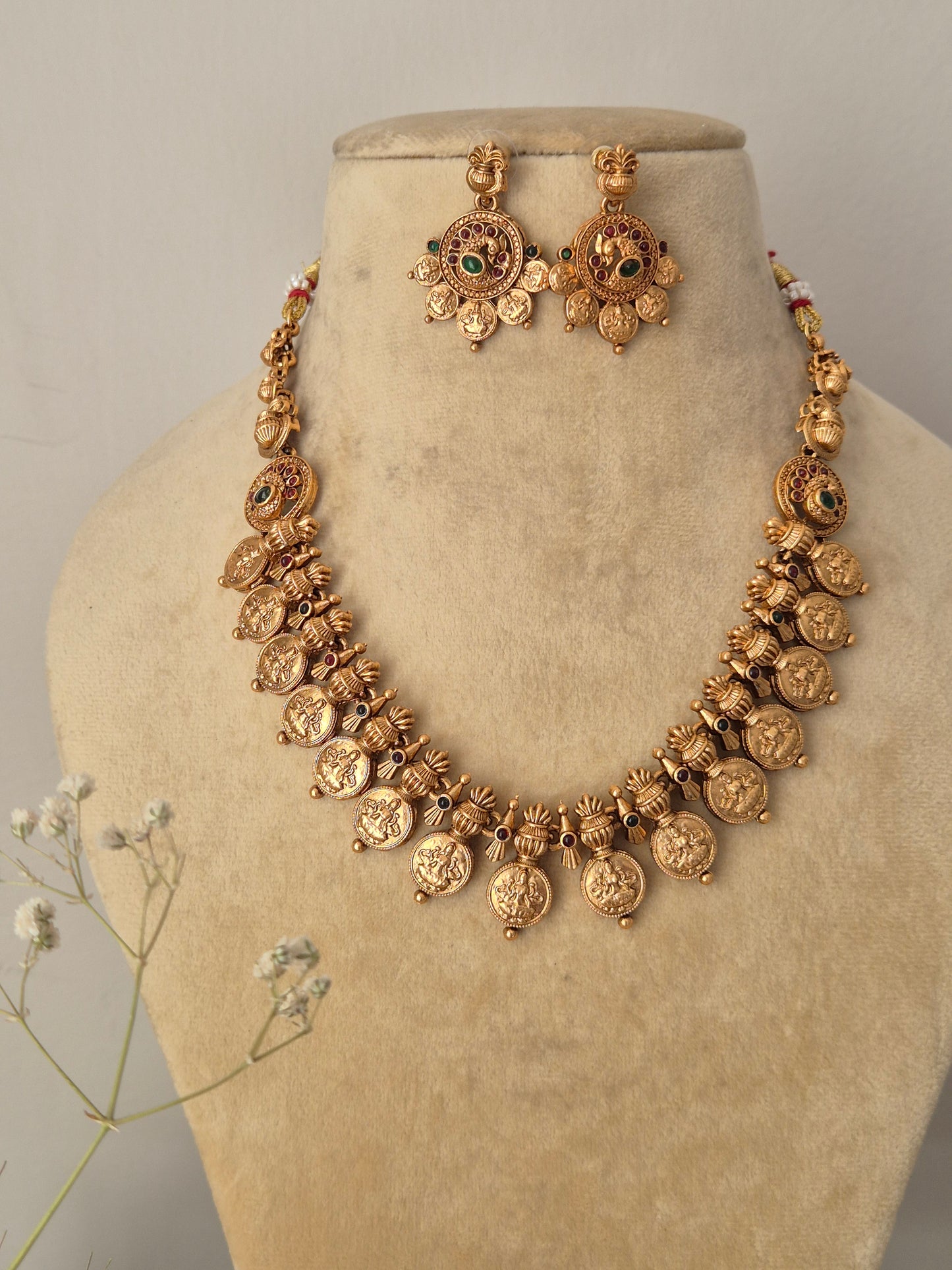 Gold-plated brass strand necklace with dangling coin fringe and coordinating stone-embellished earrings from the Naitri collection by naitri.in