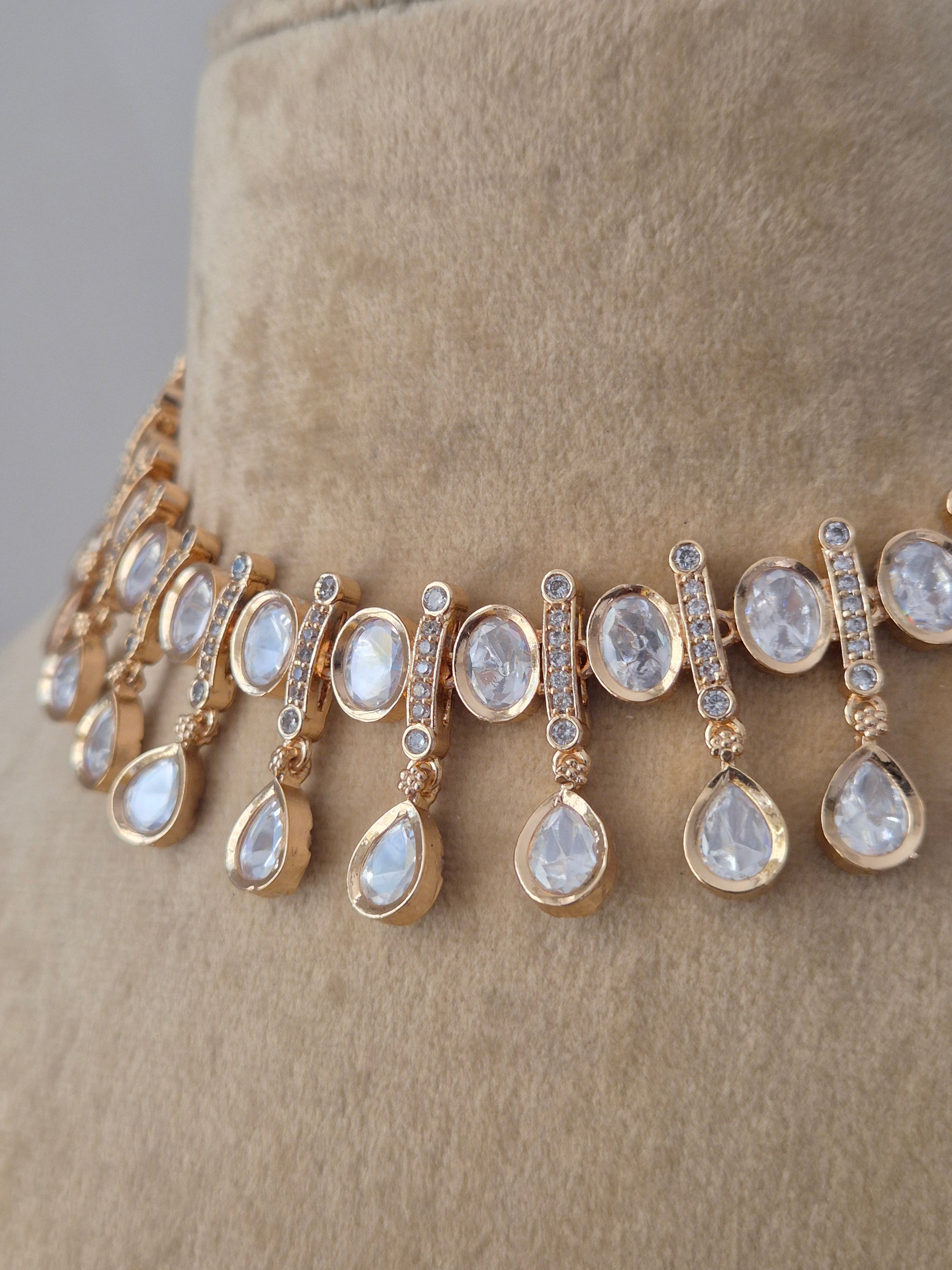 Handcrafted alloy necklace set from the Naitri collection, featuring high-quality American Diamonds in a choker style with a polished rose-gold finish by naitri.in