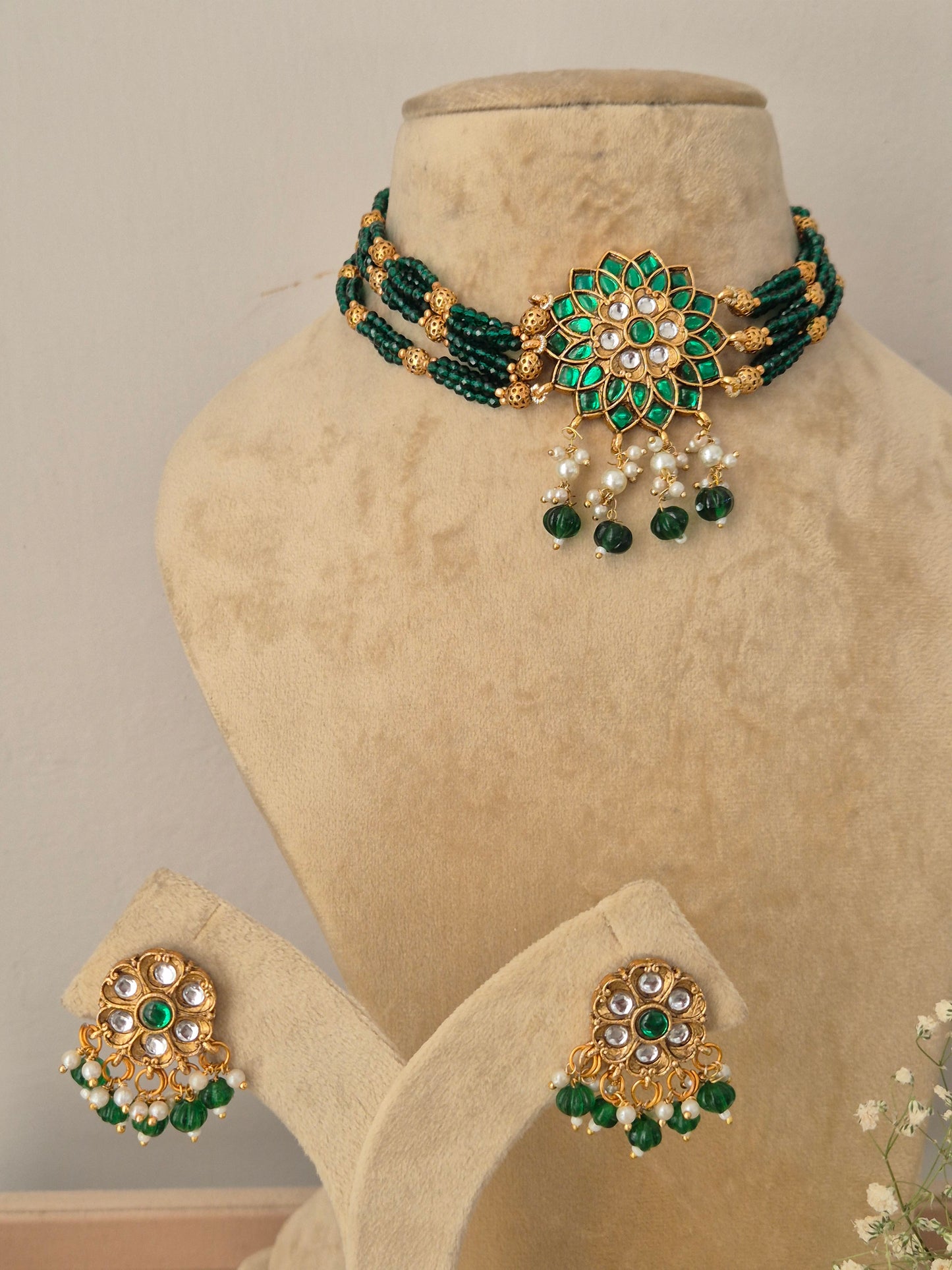 Traditional Indian style golden brass alloy green gemstone choker necklace and earring set from the NAITRI Vishakha collection by naitri.in