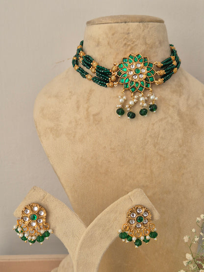 Traditional Indian style golden brass alloy green gemstone choker necklace and earring set from the NAITRI Vishakha collection by naitri.in