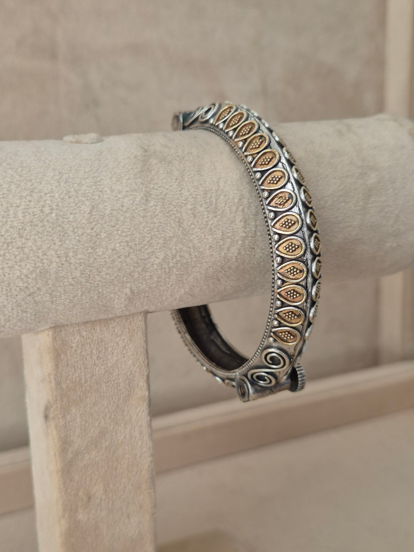 Close-up of Naitri Windiya premium mixed-metal ethnic bracelet showcasing traditional Indian craftsmanship with geometric textures and a small clasp mechanism by naitri.in