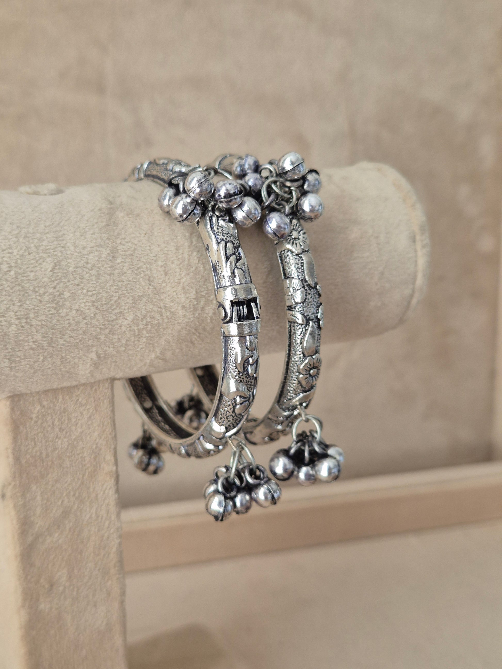 Close-up of Naitri Wishi premium oxidized silver ethnic bangles showcasing traditional Indian tribal craftsmanship with vintage hanging bell charms by naitri.in
