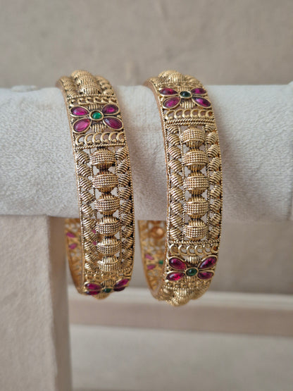 Zahira Bangles set of 2, traditional Indian gold-plated bangles with red and green stones, ethnic festive and bridal jewelry collection by Naitri.in