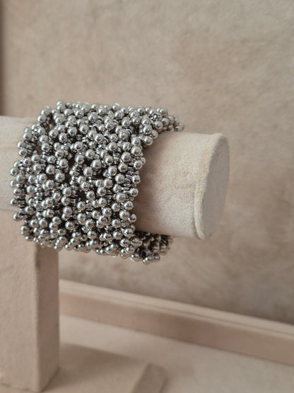 Close-up of Naitri Zani Spiral premium silver beaded statement bangle bracelet with a textured coiled design by naitri.in