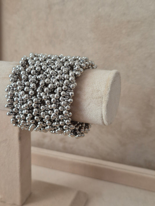 Close-up of Naitri Zani Spiral premium silver beaded statement bangle bracelet with a textured coiled design by naitri.in