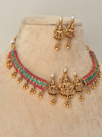 Gold-toned traditional Indian jewelry set featuring a choker necklace and matching earrings, embellished with turquoise and pink stones and small pearl-like accents, by naitri.in