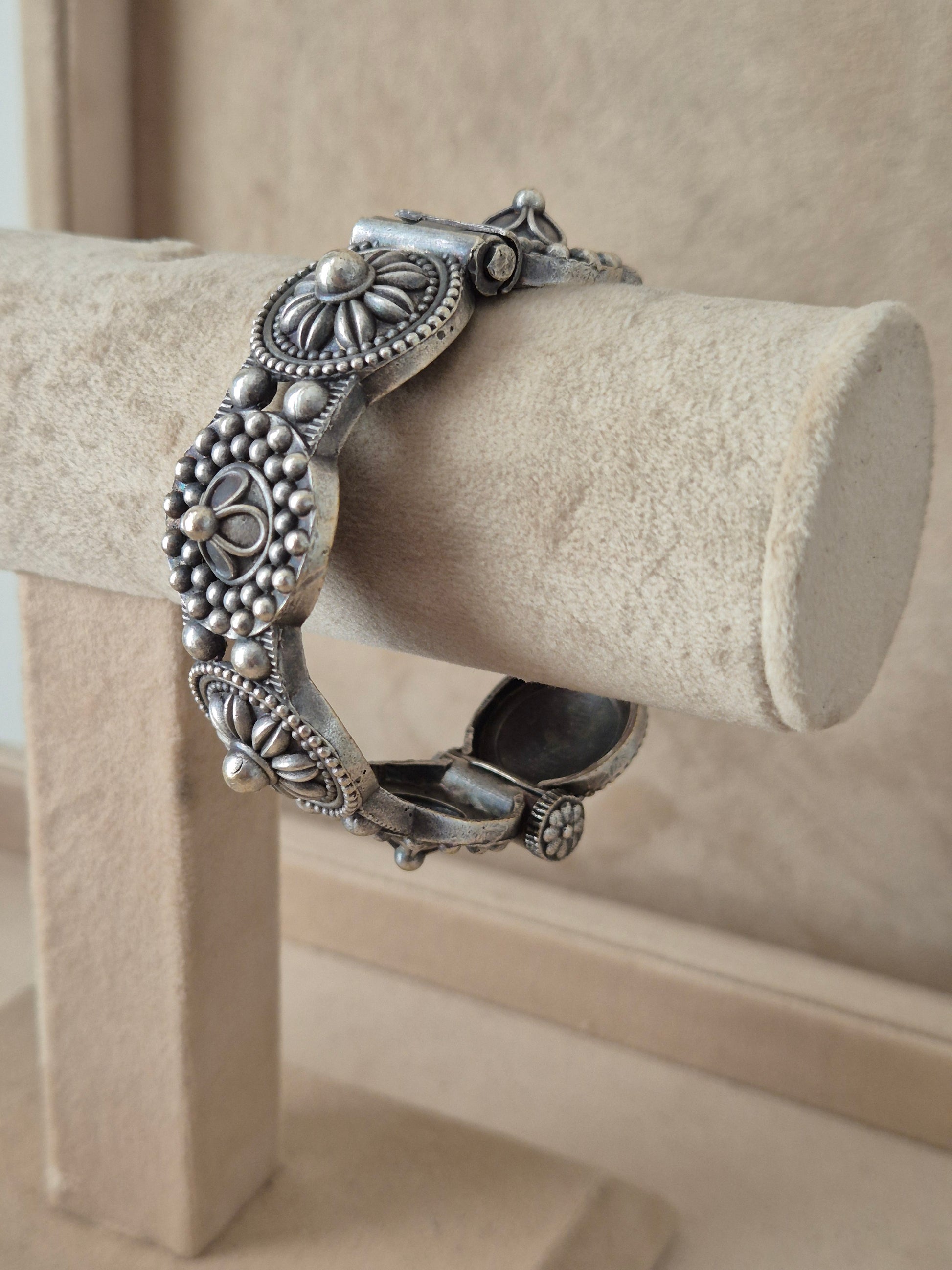 Silver bracelet Detailed antique silver oxidized bangle with an engraved floral motif by naitri.in