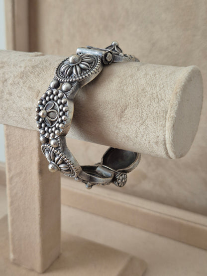 Silver bracelet Detailed antique silver oxidized bangle with an engraved floral motif by naitri.in