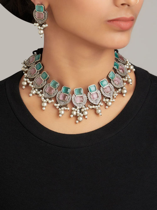 Silver and green choker necklace set, Rishika by Naitri, displayed flat.