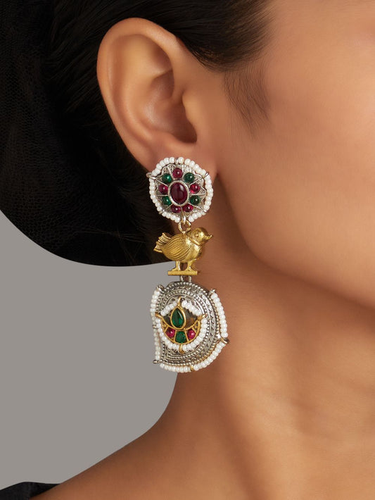 Red and silver stud earrings, Rimisha by Naitri, festive design on display.