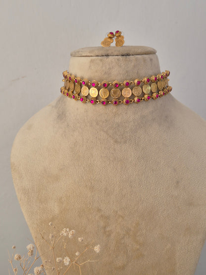 Traditional Indian gold coin-style choker necklace with red embellishments by Naitri.in