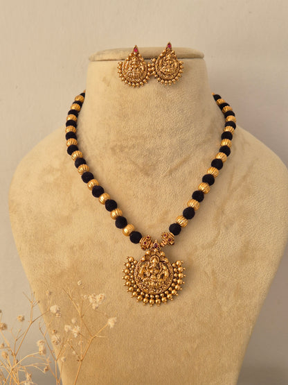 Traditional Indian ethnic gold and black bead necklace set with gemstone details by Naitri.in