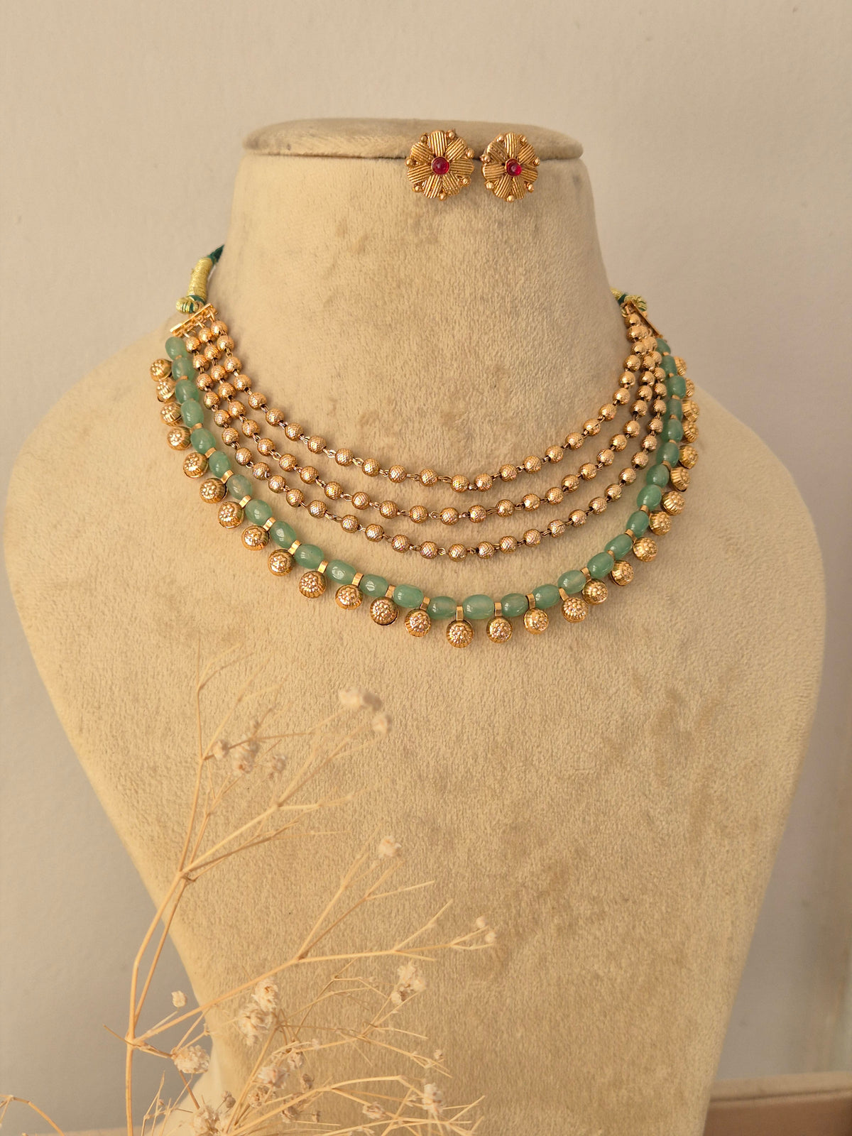 Traditional Indian Layered Necklace Set showcased against a neutral background, highlighting the delicate multi-tiered bead chains, polished gold accents, and ethnic craftsmanship by Naitri.in