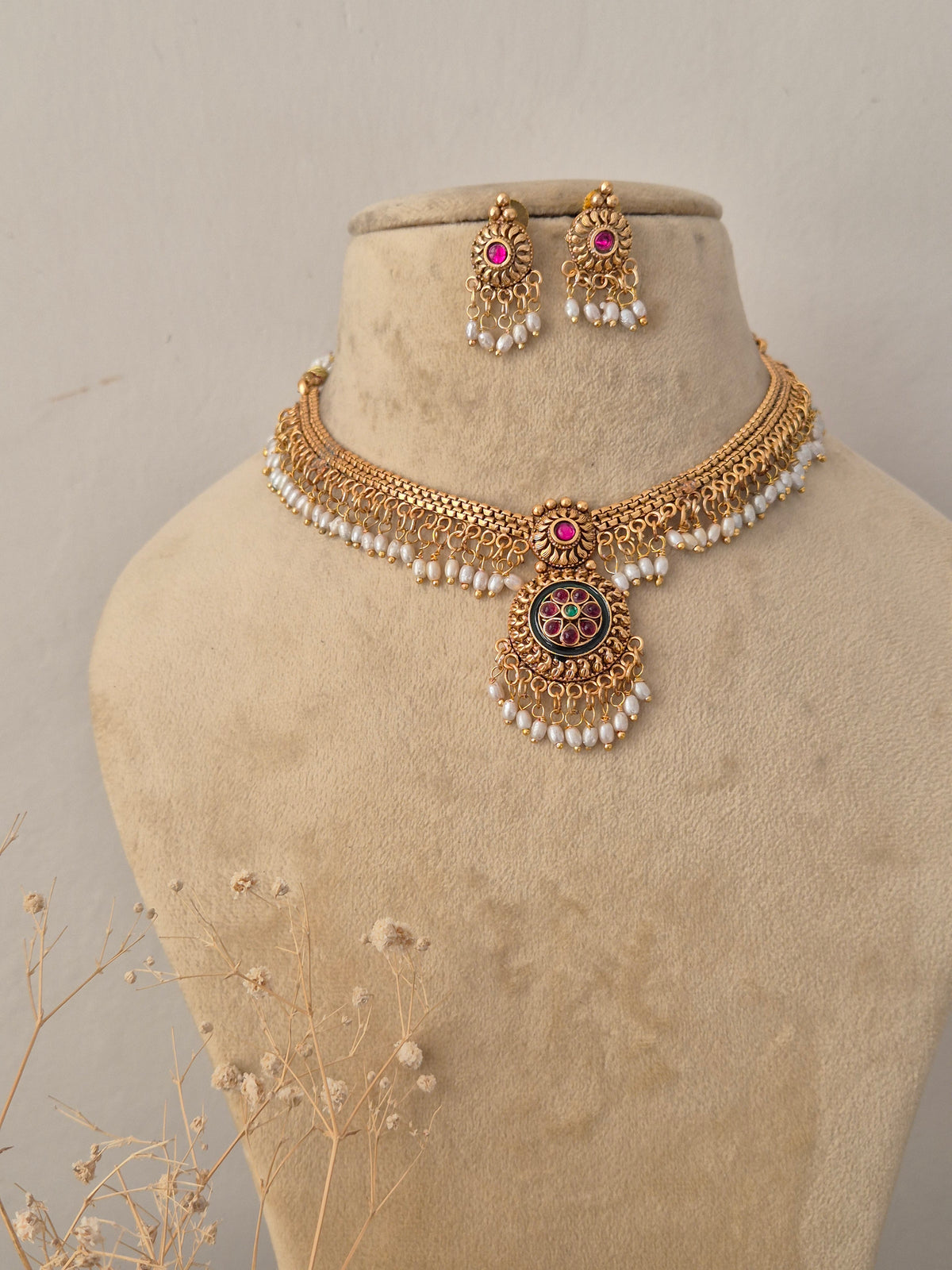 Traditional Indian ethnic gold necklace set with gemstone details by Naitri.in