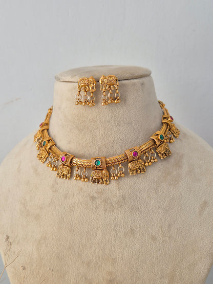 handcrafted Mannu Necklace Set against a simple, distraction-free backdrop. The polished gold finish and ethnic styling of both the choker and matching earrings are clearly highlighted. This professional view is ideal for showcasing the traditional Indian aesthetic on your storefront by Naitri.in