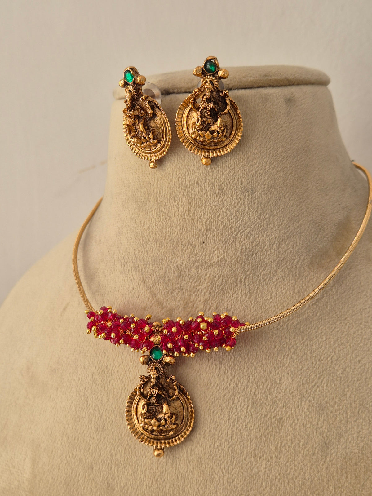 Handcrafted brass alloy choker necklace and matching stud earrings from the Naitri golden jewelry collection by Naitri.in