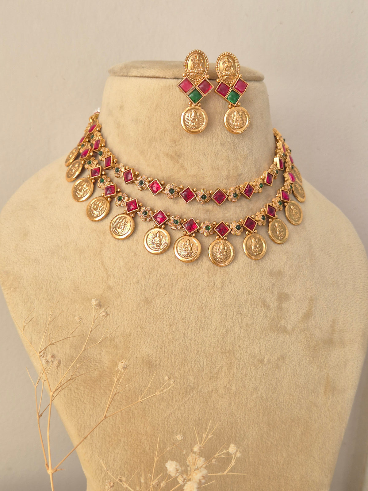 Handcrafted brass alloy traditional Indian necklace set with intricate deity carvings and stone embellishments by Naitri.in
