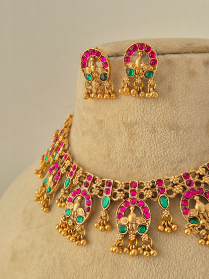 Handcrafted brass alloy ethnic necklace and matching earrings featuring traditional Indian temple design by Naitri.in