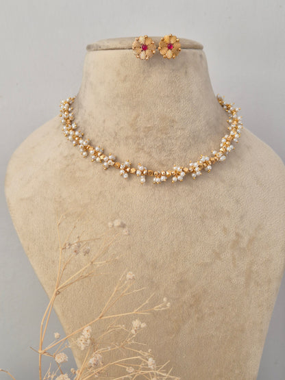 Traditional Indian Imitation Jewelry showcased against a clean background, highlighting the intricate red gemstone detailing, polished gold-tone finish, and classic ethnic craftsmanship by Naitri.in