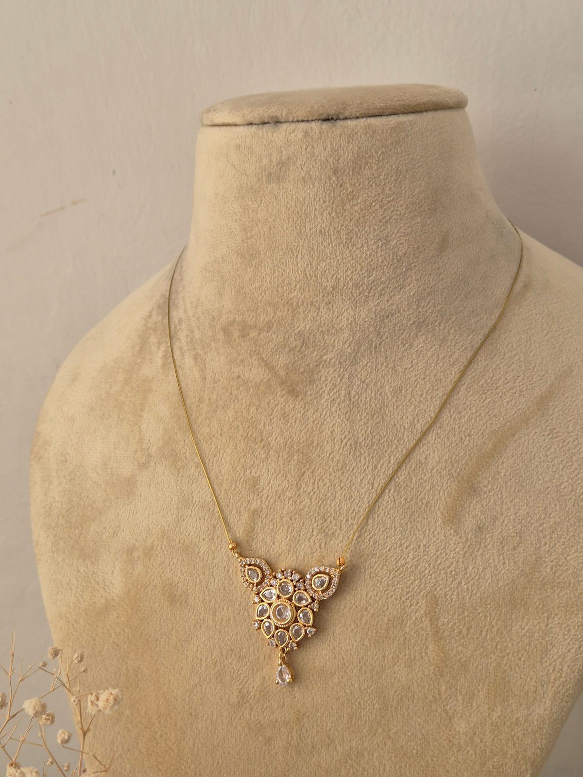 Handcrafted brass alloy traditional Indian pendant necklace on a fine gold-tone invisible chain by Naitri.in