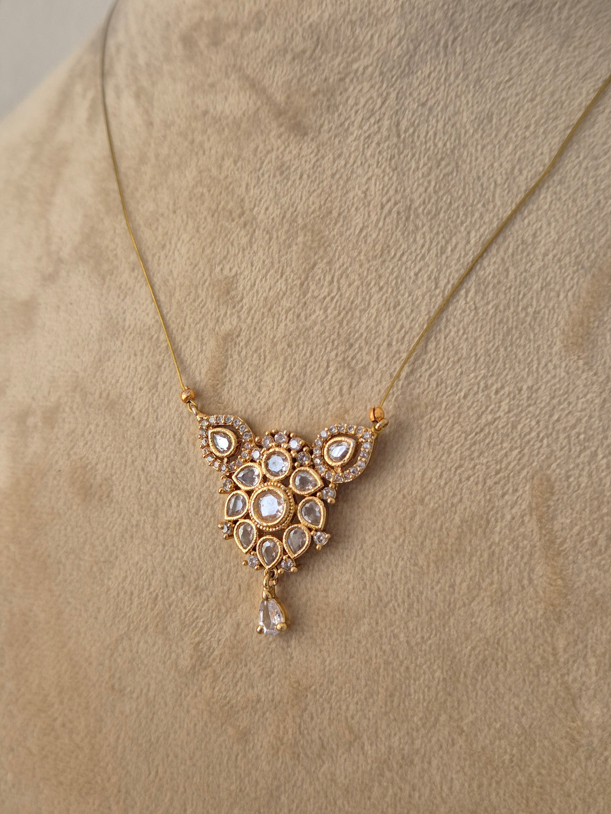 Traditional Indian ethnic gold pendant necklace with intricate craftsmanship by Naitri.in