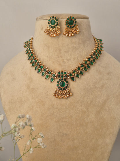 Traditional Indian gold-plated necklace set with green  stones by naitri.in