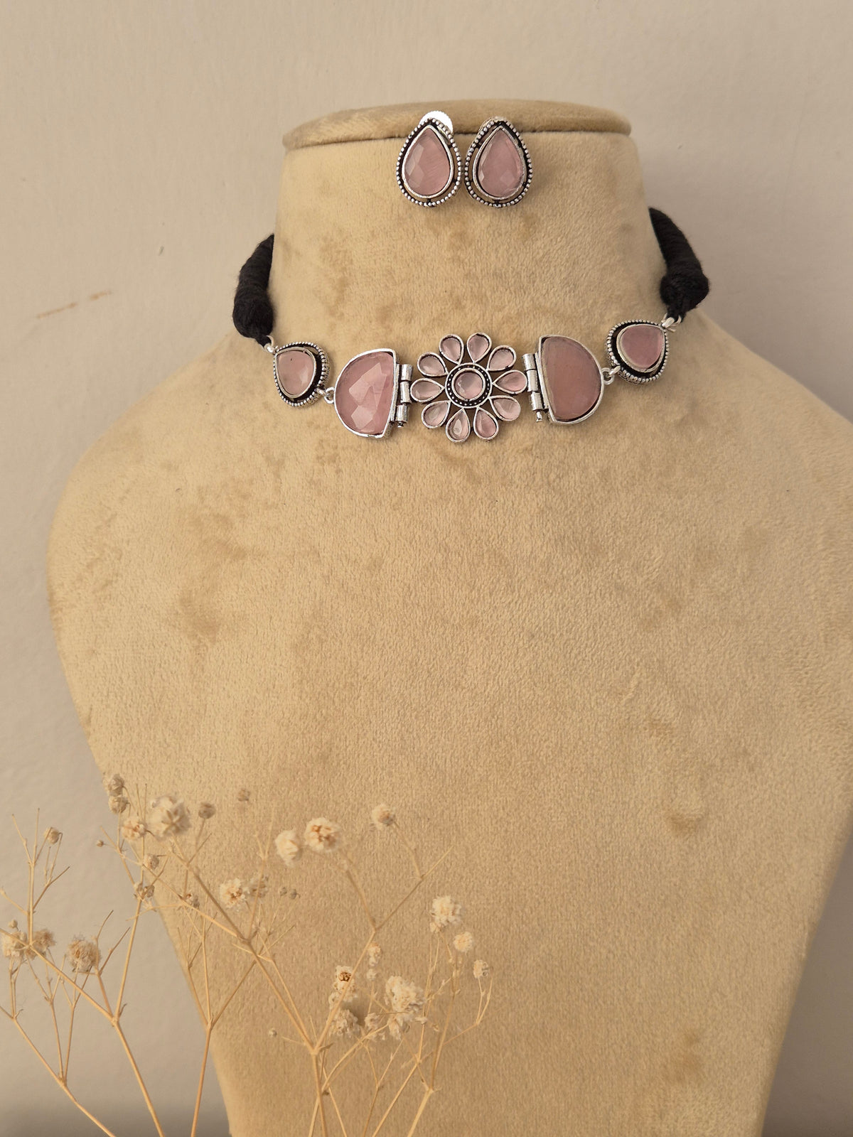 Elegant ethnic choker necklace with soft pink floral centerpiece designs, complemented by matching traditional earrings by Naitri.in