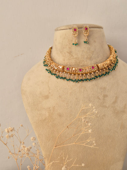 Traditional Indian ethnic gold necklace and earring set with gemstone details by Naitri.in