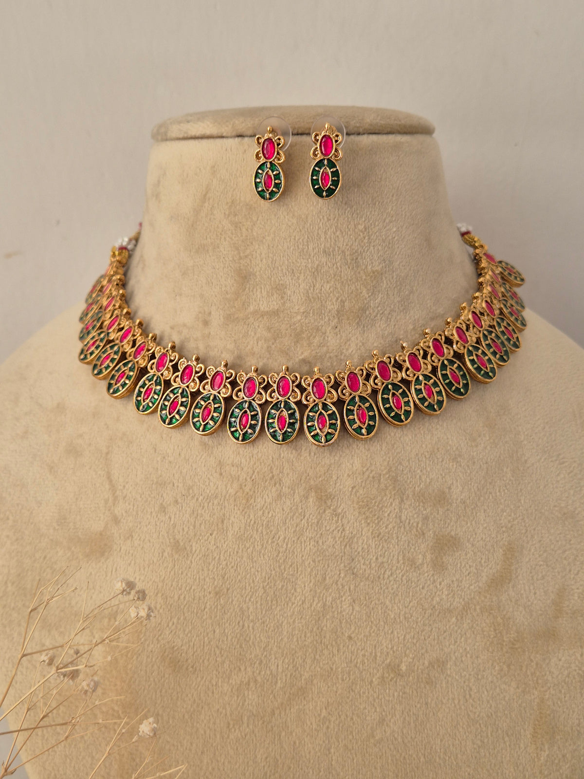 Traditional Indian gold-plated necklace paired with matching teardrop stud earrings by Naitri.in