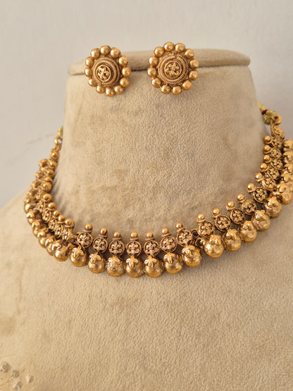Traditional Indian gold-plated choker necklace featuring intricate temple motifs paired with matching round stud earrings by Naitri