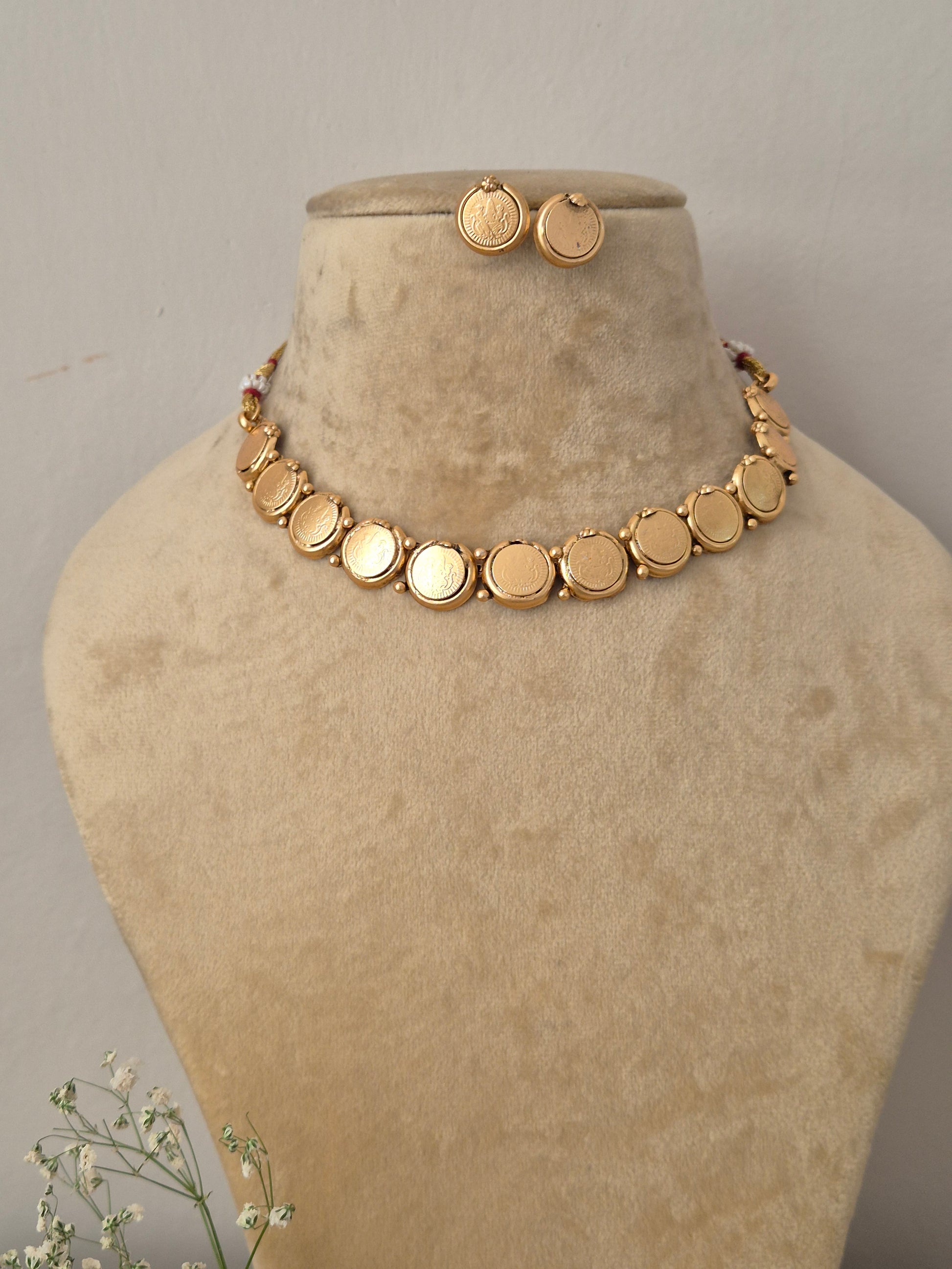 Modern Indian style delicate golden brass alloy coin choker necklace and earring set from the NAITRI, Handcrafted antique gold statement choker set by naitri.in