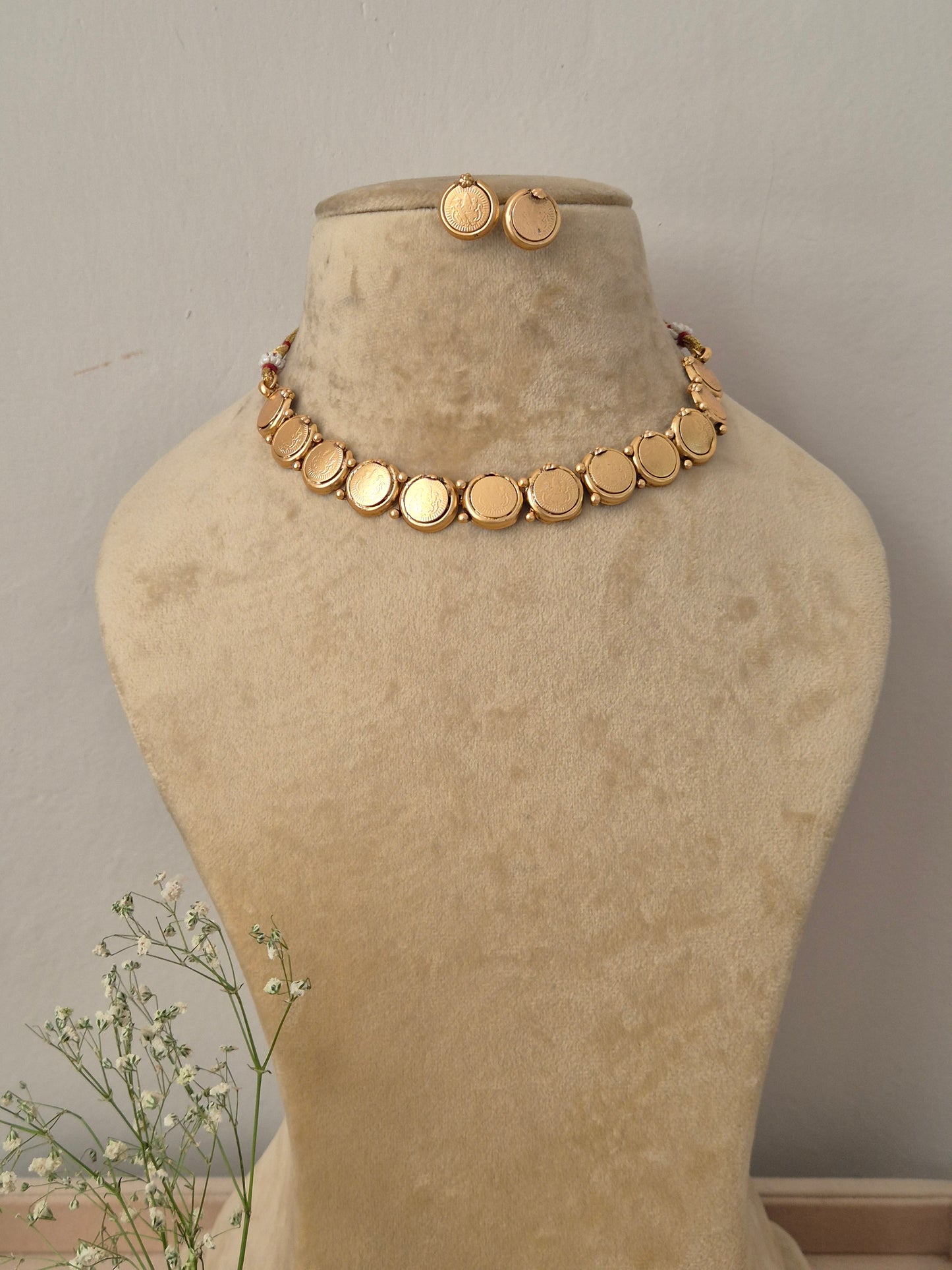 Minimalist gold choker necklace with flat circular disc charms and matching small stud earrings by naitri.in