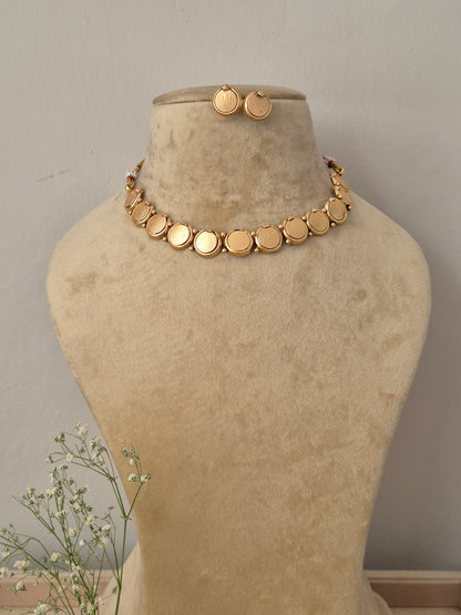 Minimalist gold choker necklace with flat circular disc charms and matching small stud earrings by naitri.in