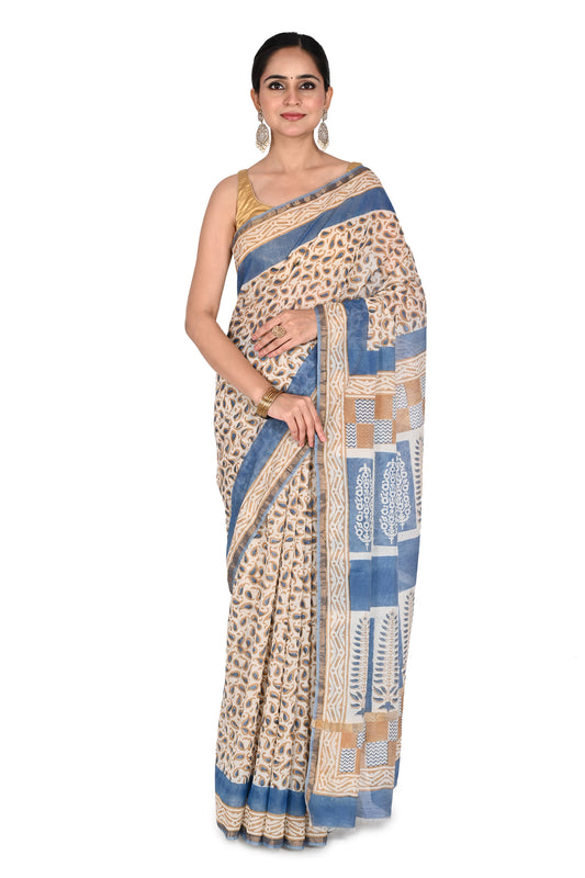 Woman modeling a blue and beige hand block printed cotton silk saree with intricate geometric patterns and a classic drape by naitri.in