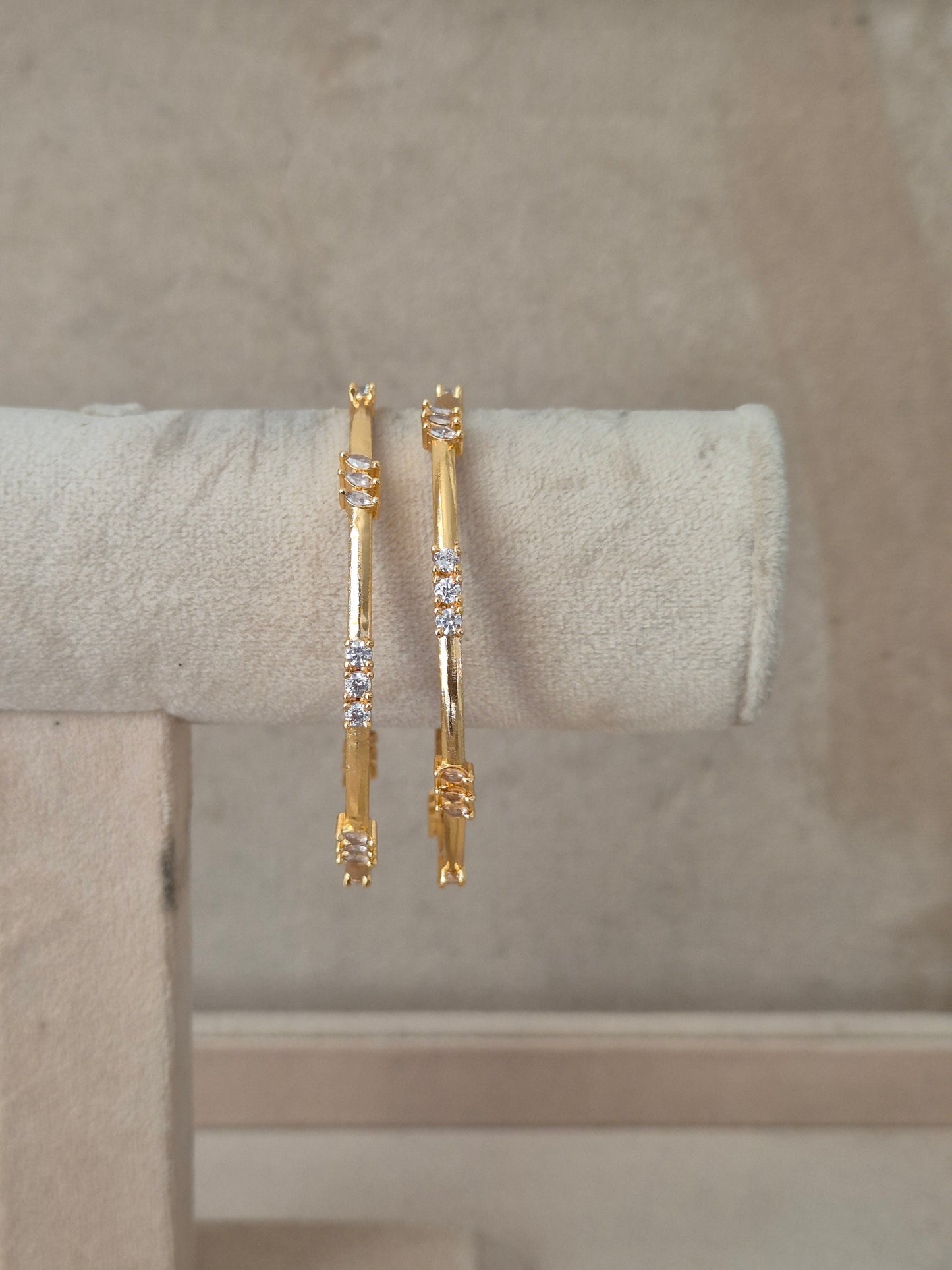 Two gold-toned bangle bracelets with small clear stones, by naitri.in