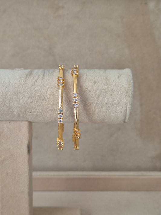 Two gold-toned bangle bracelets with small clear stones, by naitri.in