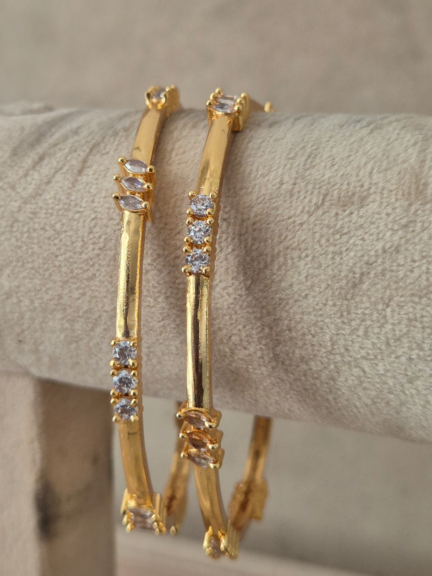 Pair of traditional Indian gold bangles showcasing fine artisan metalwork, textured detailing, and classic motifs by naitri.in