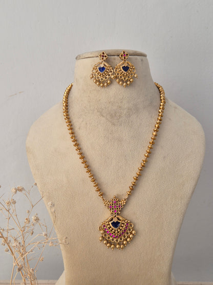  Neetu Necklace Set featuring a traditional gold mangalsutra-style black beaded chain with an intricate temple pendant and matching earrings by Naitri.in
