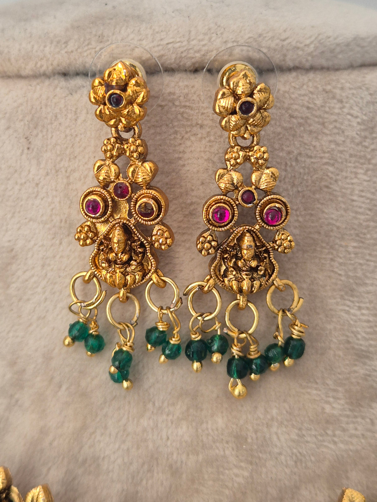 Gold temple earrings  with pink stones and green bead drops by naitri.in