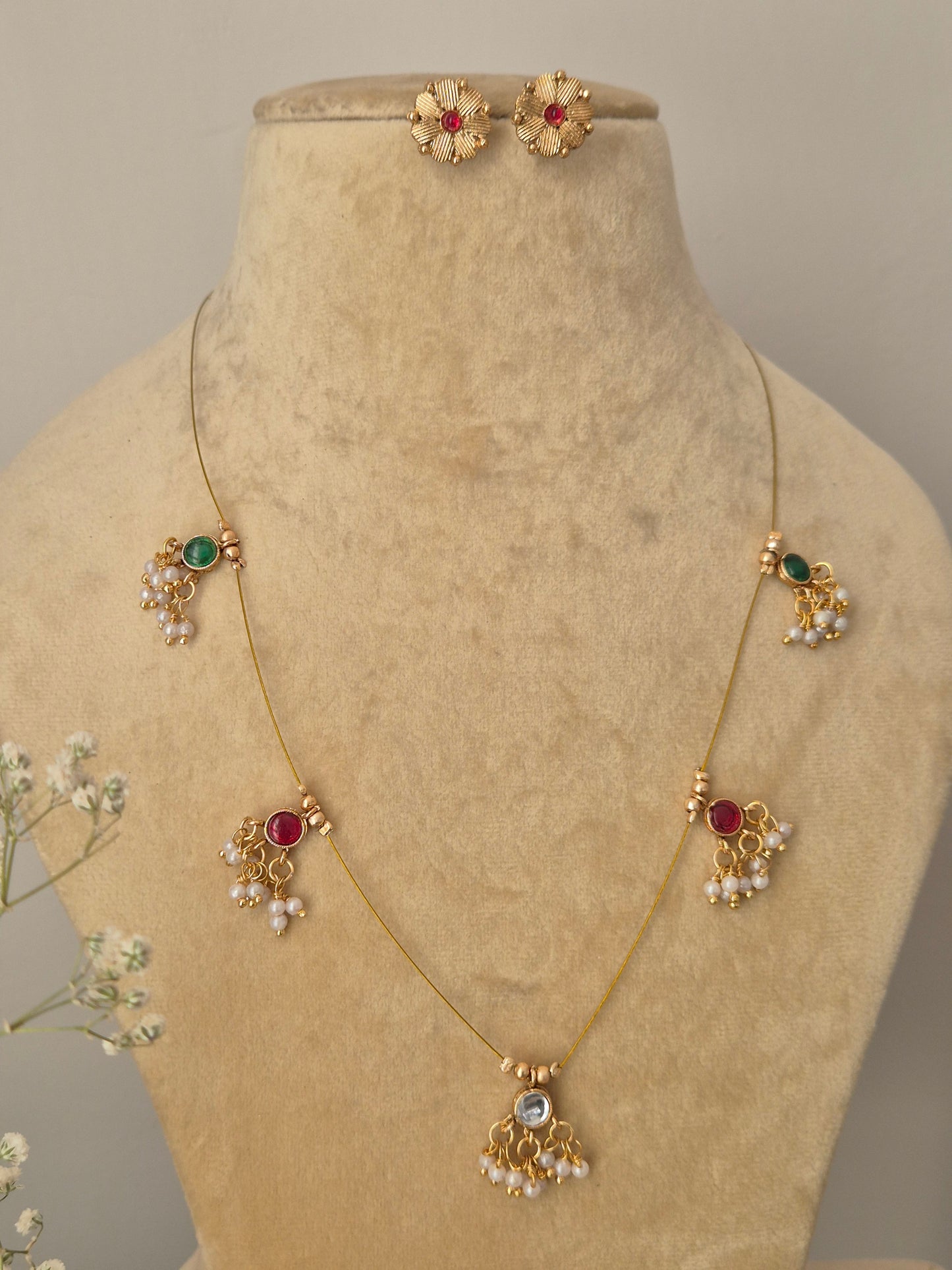 Traditional Indian-inspired reversible gold necklace set with delicate chain and vibrant stone embellishments, by naitri.in
