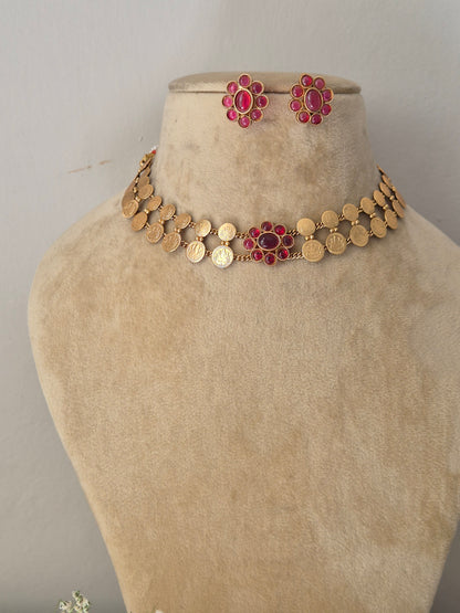 Handcrafted antique gold statement jewelry set showcasing festive pink  floral accents by naitri.in