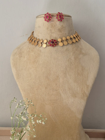 Antique gold choker necklace featuring a central pink stone pendant, with matching earrings by naitri.in
