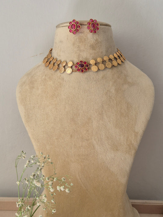 Antique gold choker necklace featuring a central pink stone pendant, with matching earrings by naitri.in
