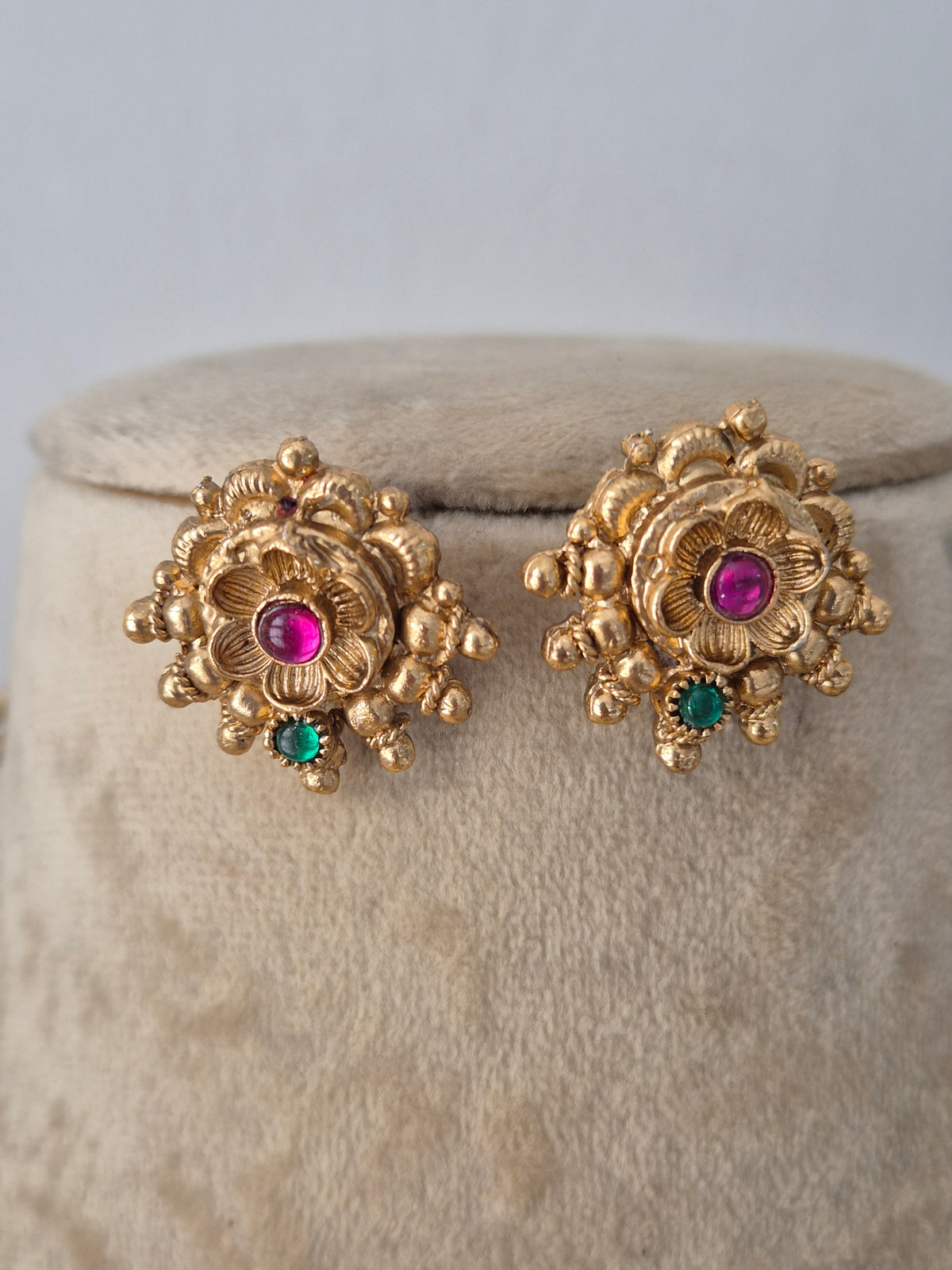 Gold-toned ethnic earring set with traditional temple and animal motifs by Naitri.in