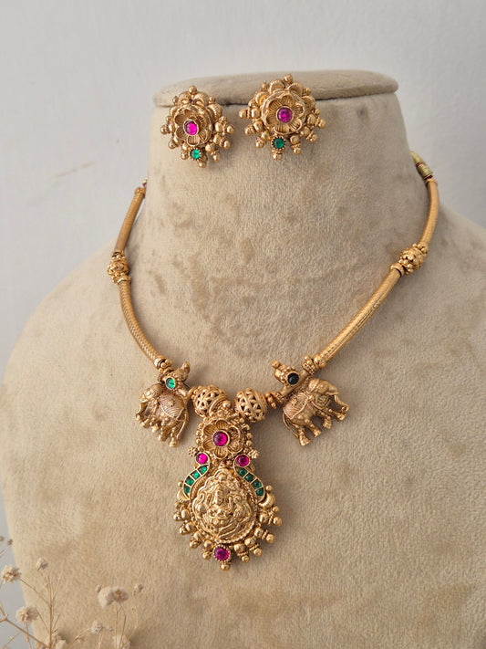 Traditional Indian gold temple-design necklace set with colorful gemstone embellishments by Naitri