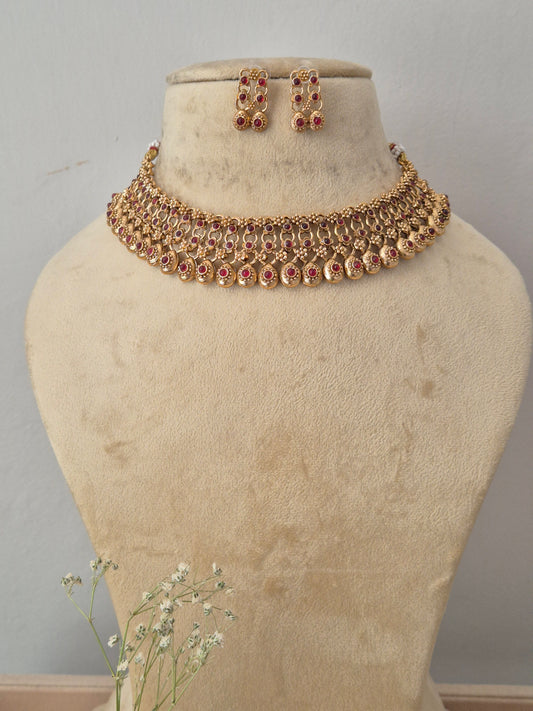 Gold-toned traditional jewelry set featuring a statement collar necklace and matching drop earrings, by naitri.in