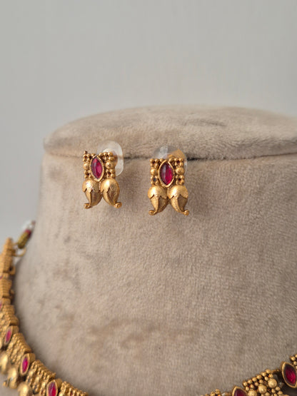 A showstopper piece with red stones and golden leaves design by naitri.in