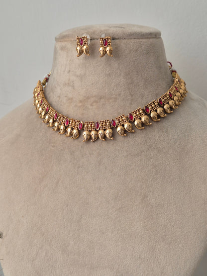 Handcrafted Masterpiece with lots  Detailing golden necklace and earrings with red stones by naitri.in
