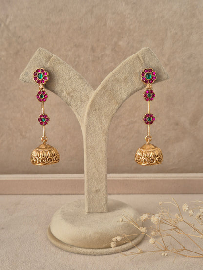 Gold-plated long stone-studded jhumka earrings by naitri.in