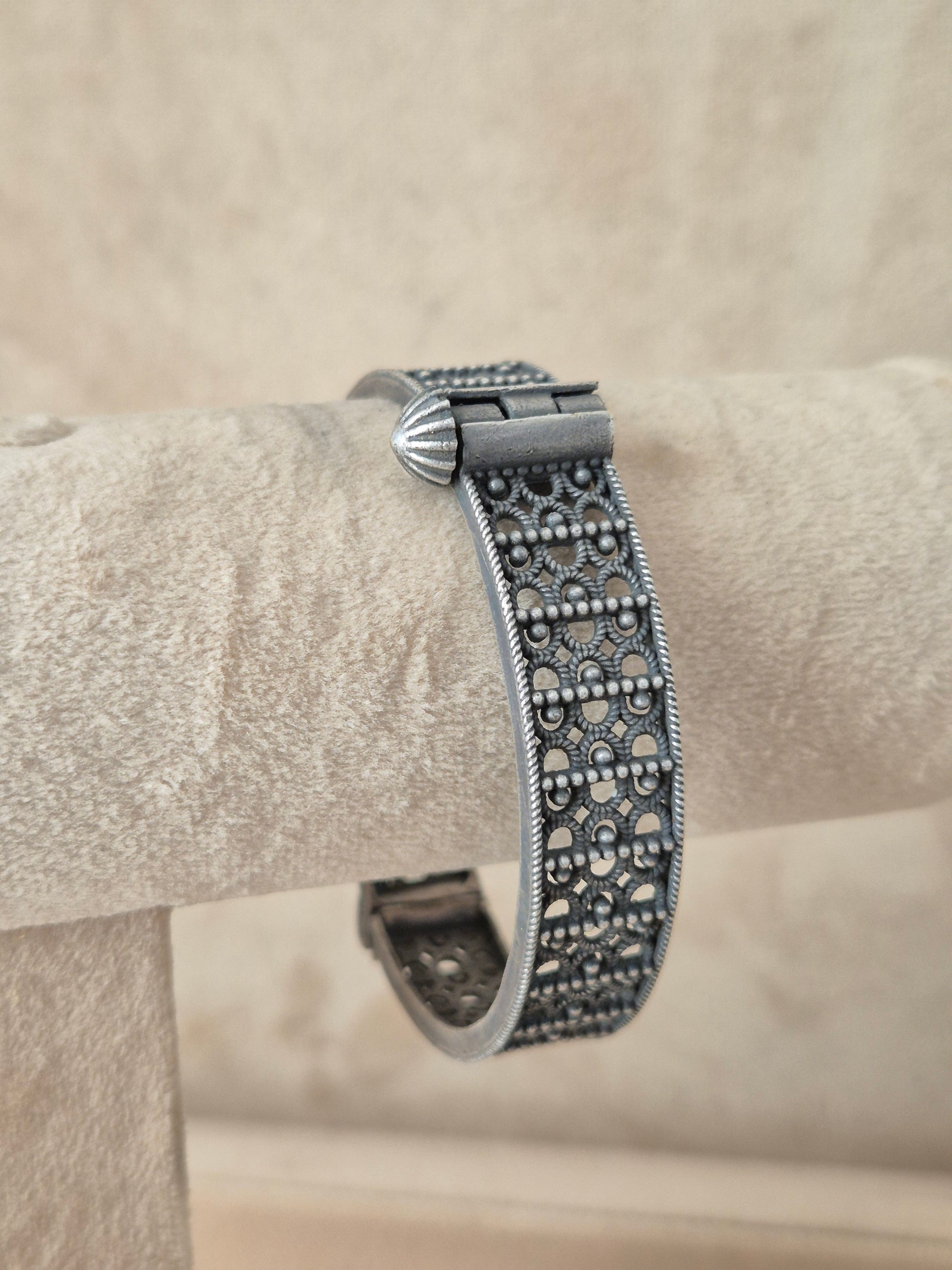 Detailed antique silver oxidized bangle with an engraved floral motif by naitri.in